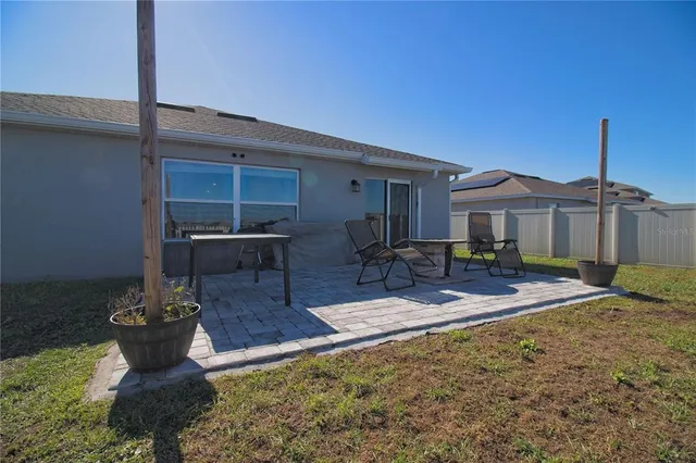 a view of a house with backyard and sitting area
