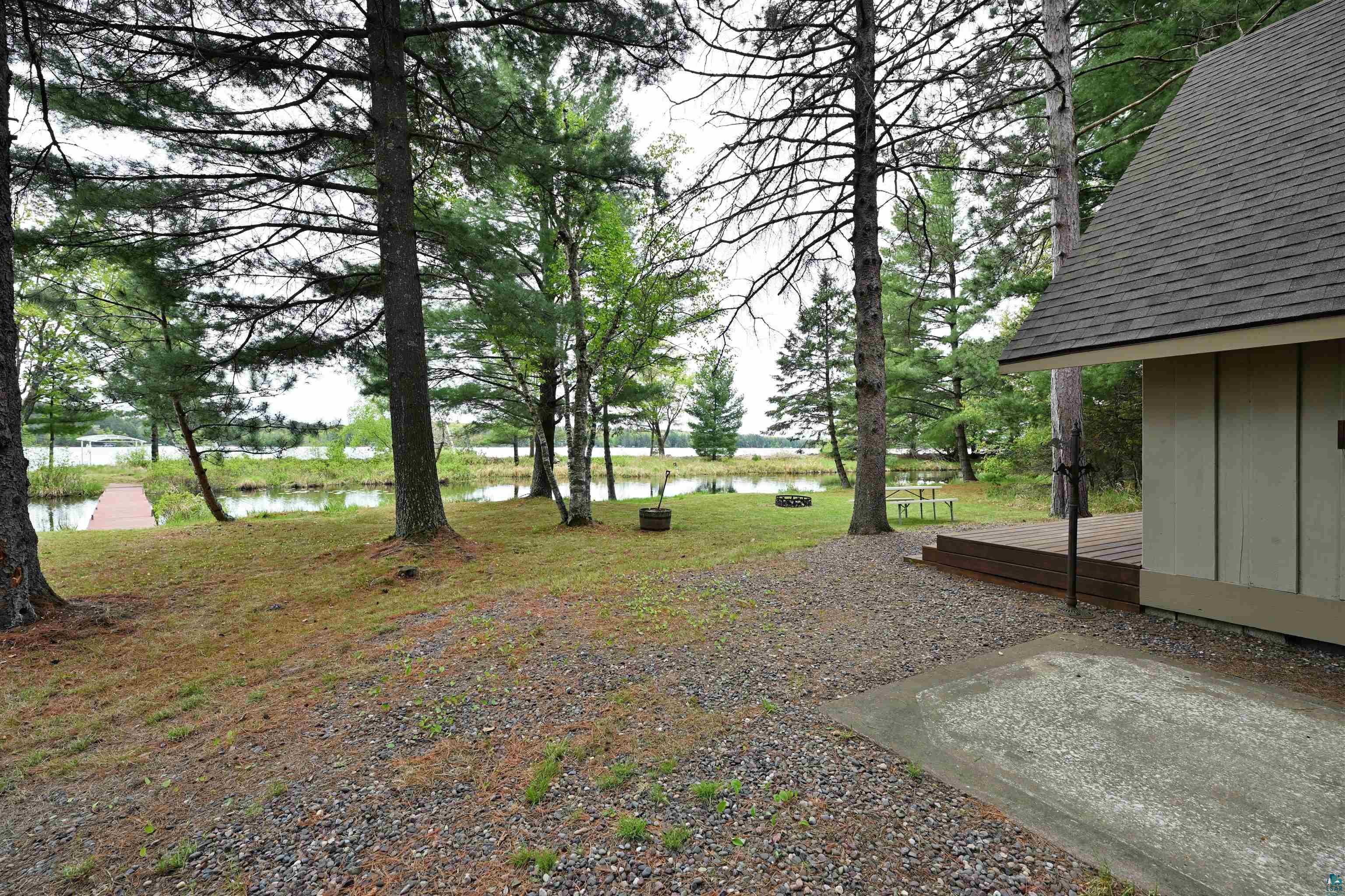 2775 Lake Road Barnes, WI 54873 - Photo 21 of 52 View of grassy yard featuring a deck with water view