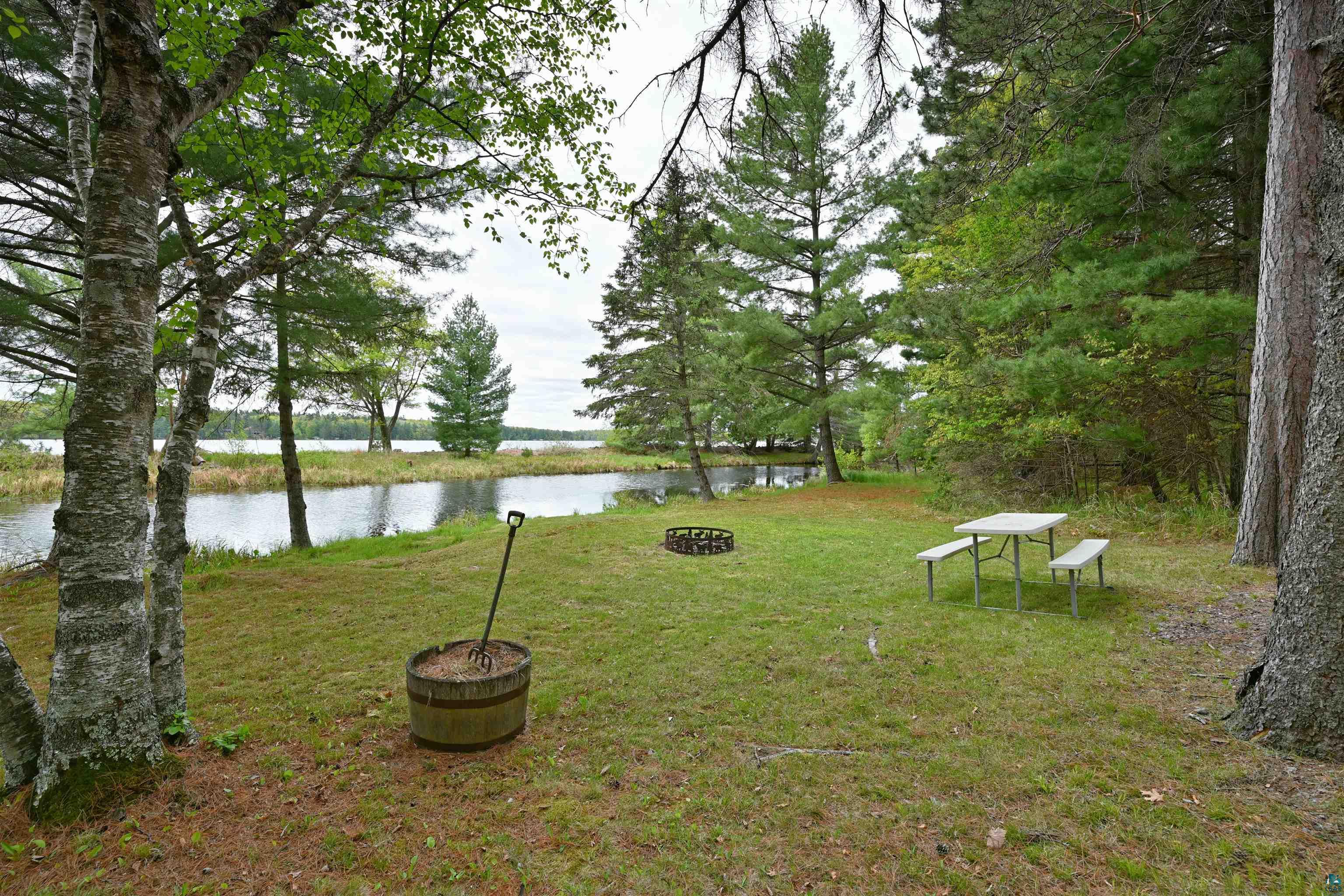 2775 Lake Road Barnes, WI 54873 - Photo 25 of 52 View of green lawn featuring a water view and an outdoor fire pit
