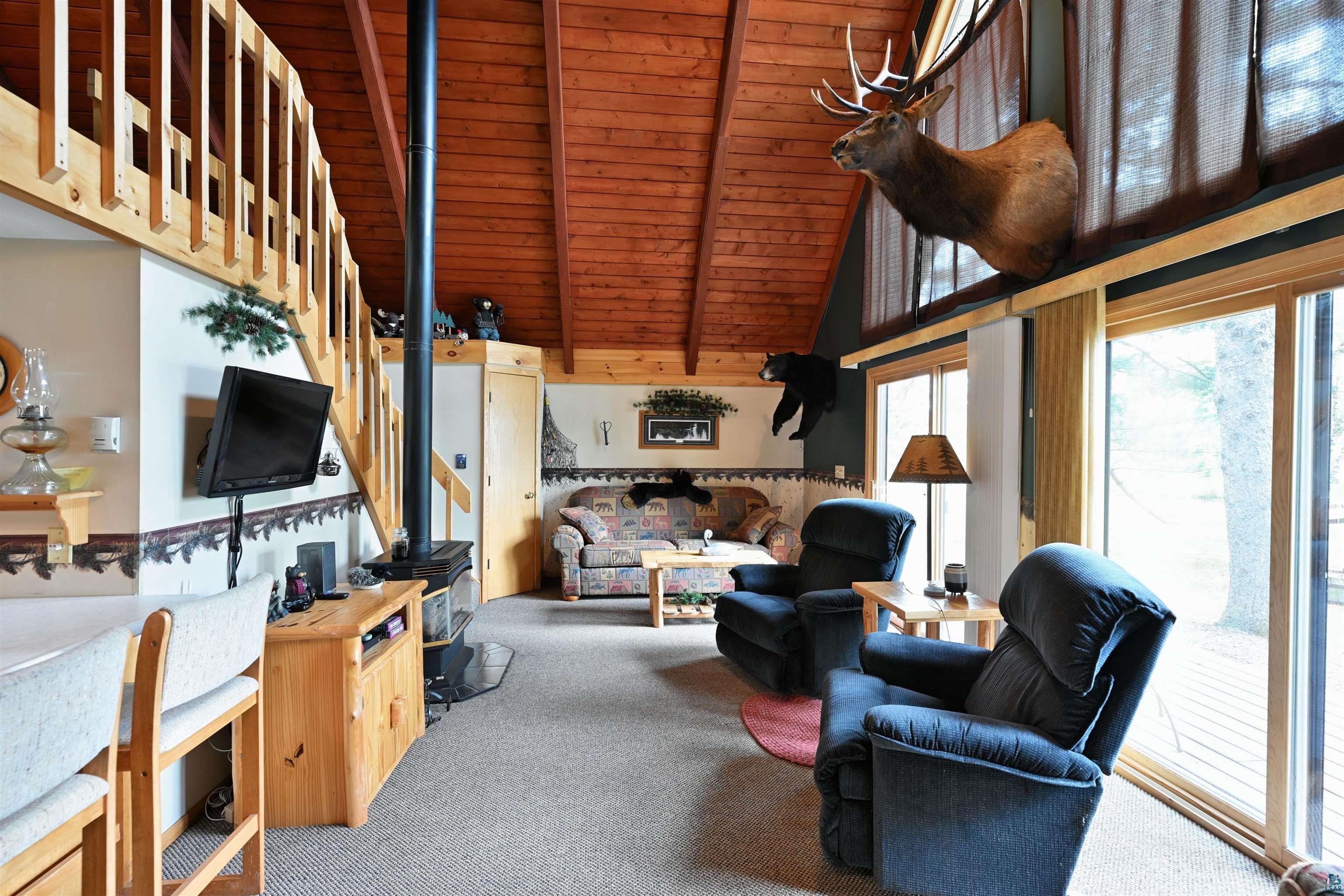 2775 Lake Road Barnes, WI 54873 - Photo 41 of 52 Carpeted living area featuring a high wood beamed ceiling