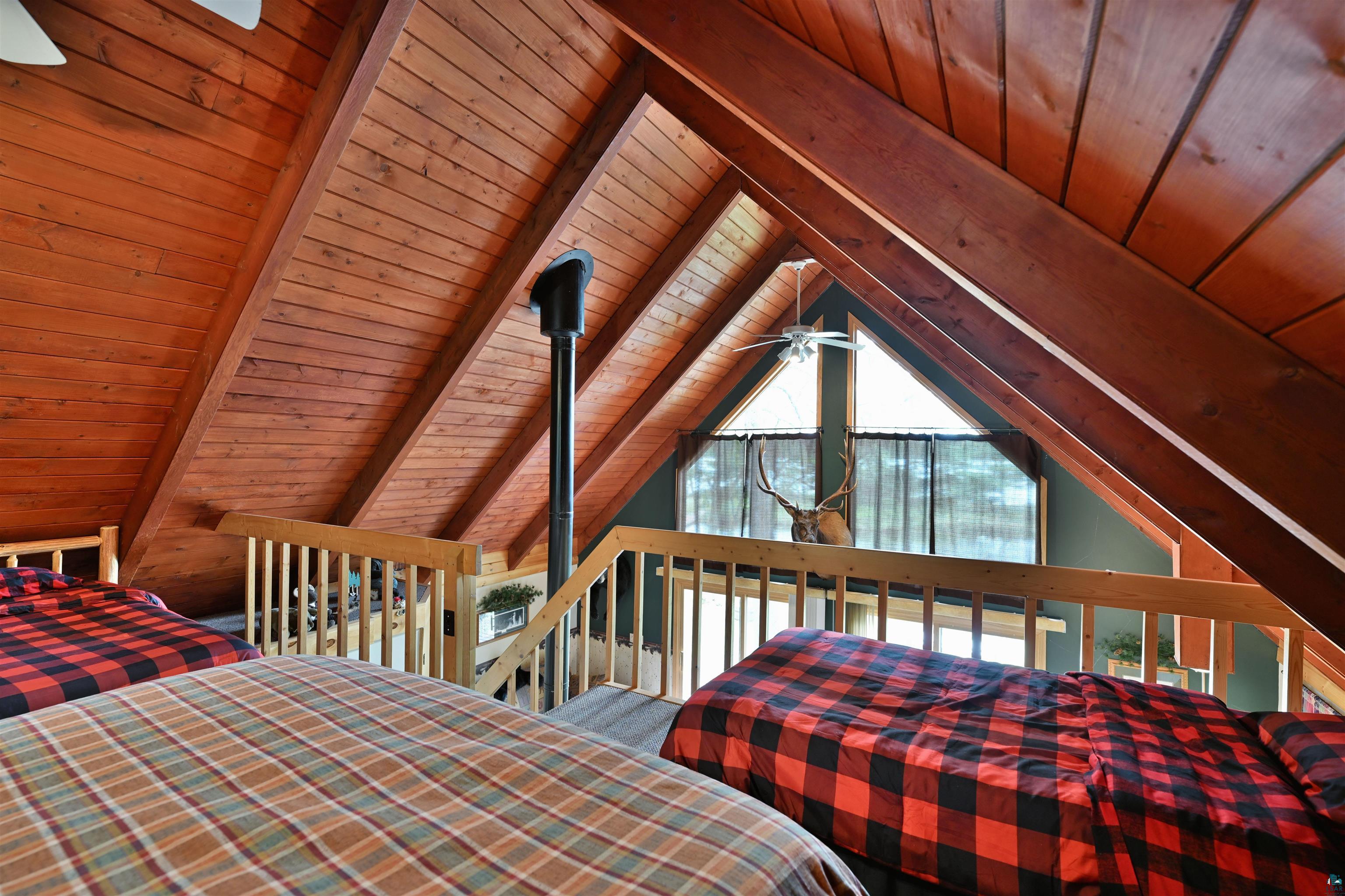 2775 Lake Road Barnes, WI 54873 - Photo 47 of 52 Bedroom featuring a wood ceiling with exposed beams