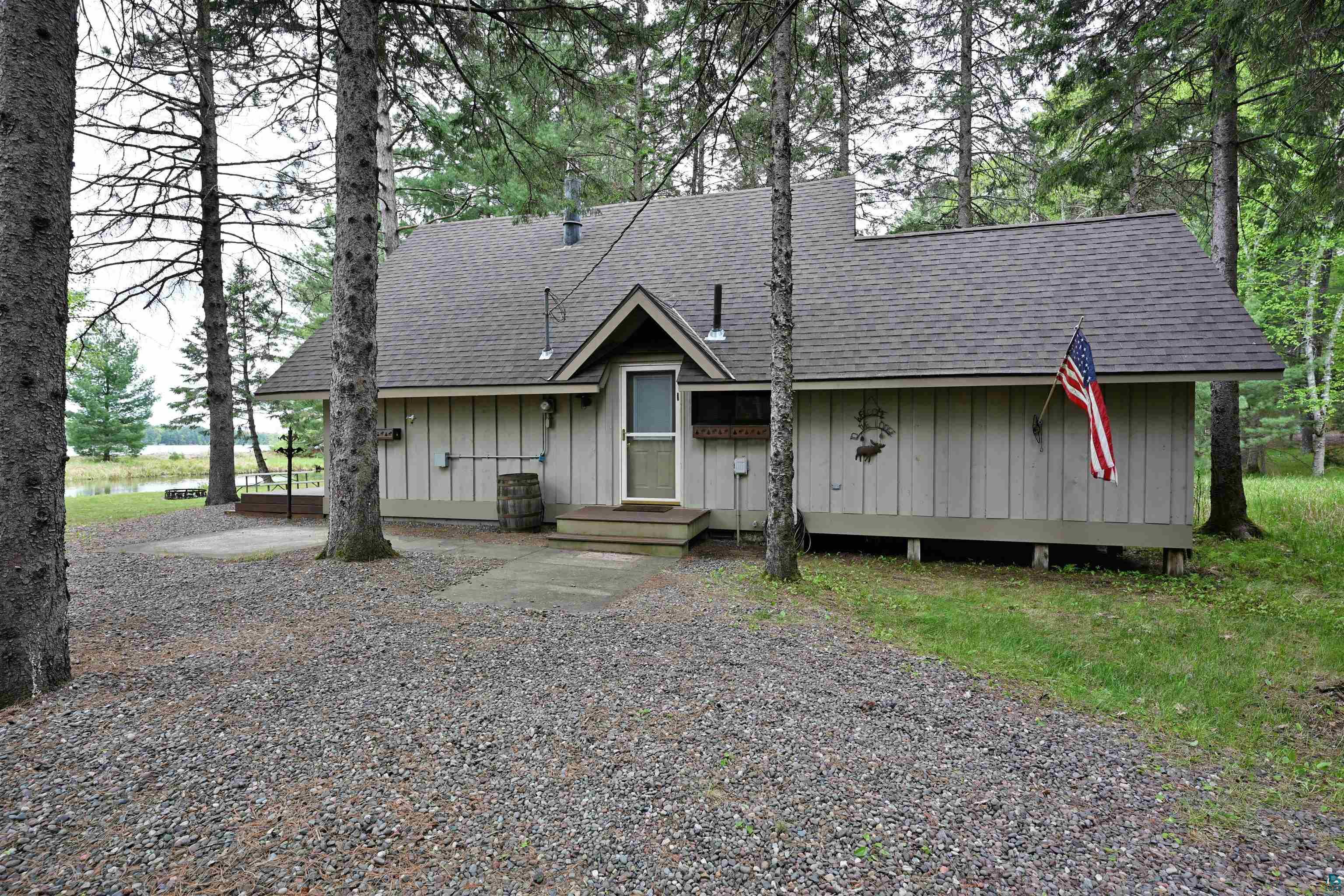2775 Lake Road Barnes, WI 54873 - Photo 5 of 52 View of front facade featuring a shingled roof and board and batten siding