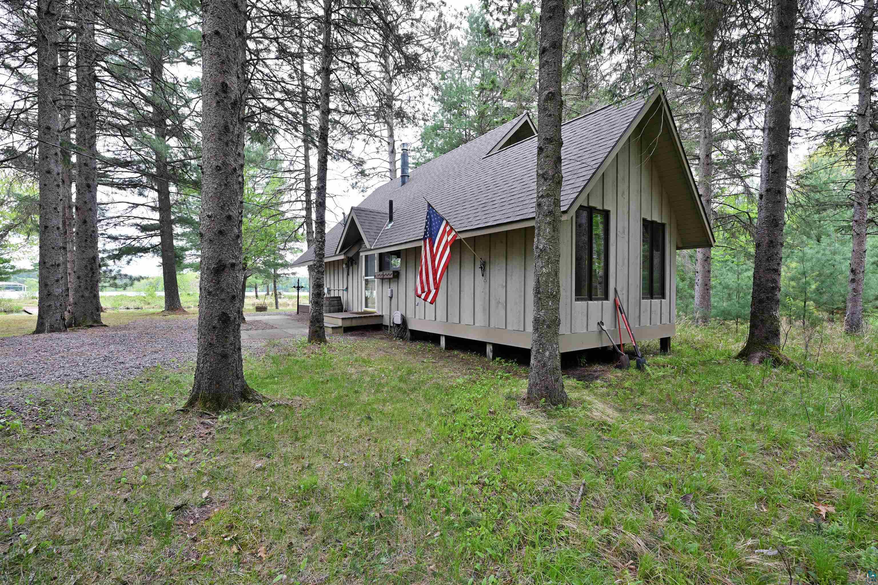 2775 Lake Road Barnes, WI 54873 - Photo 6 of 52 Rustic home with roof with shingles, board and batten siding, and a front yard