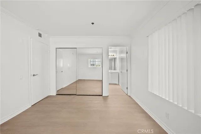 a view of a hallway with wooden shelves