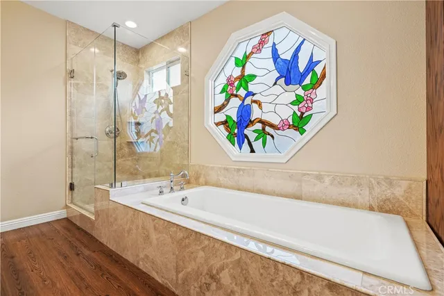 a bathroom with a bathtub and a shower