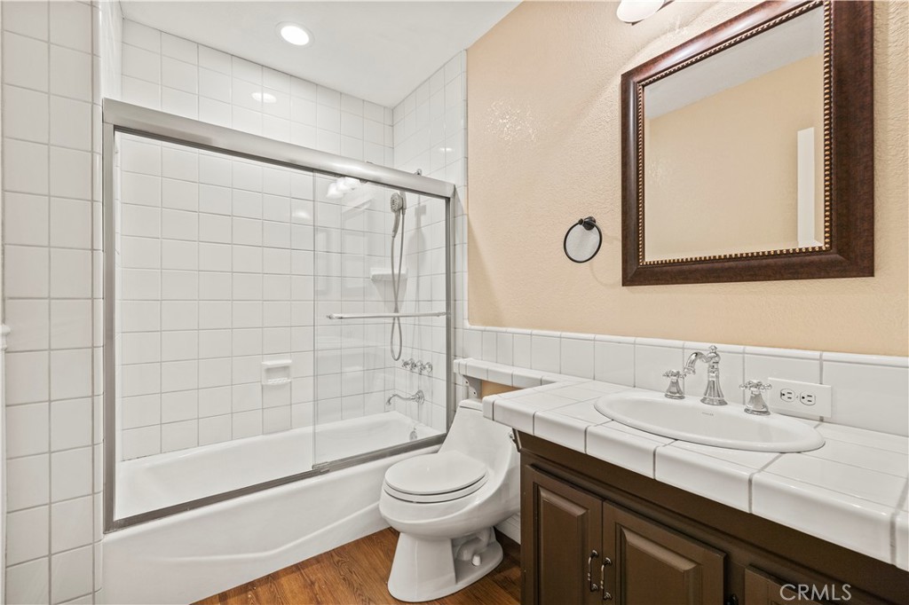 24123 Wildwood Canyon Road Newhall, CA 91321 - Photo 17 of 32 a bathroom with a sink a toilet and shower