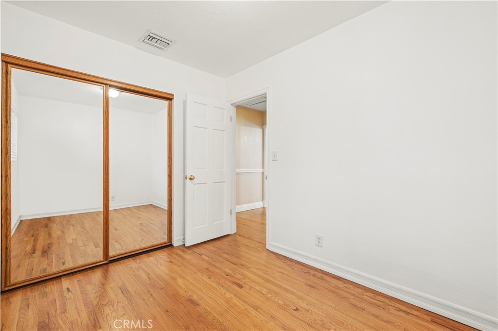 24123 Wildwood Canyon Road Newhall, CA 91321 - Photo 19 of 32 a view of an empty room with wooden floor