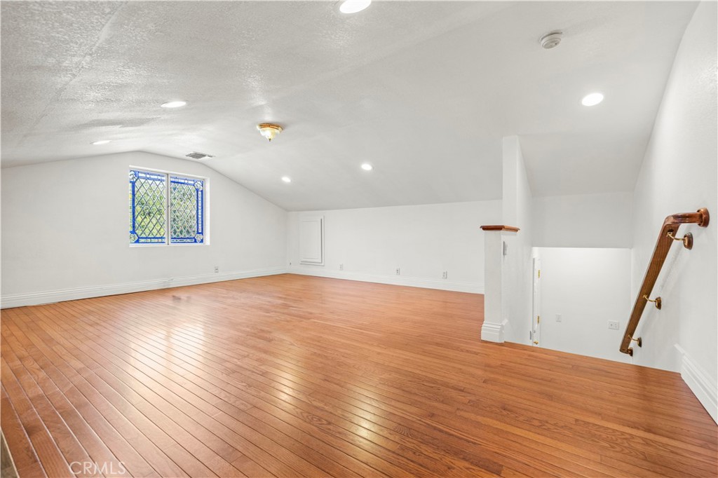 24123 Wildwood Canyon Road Newhall, CA 91321 - Photo 8 of 32 a view of empty room with wooden floor and window