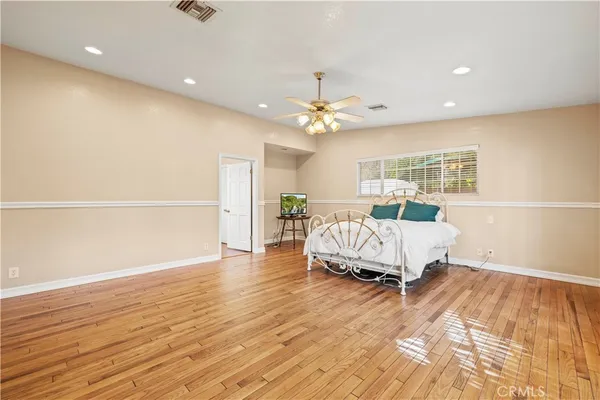 a spacious bedroom with a bed and a table in it