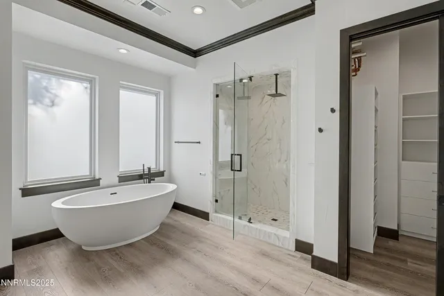 a spacious bathroom with a bathtub and shower