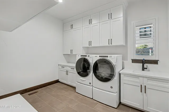 a utility room with sink dryer and washer