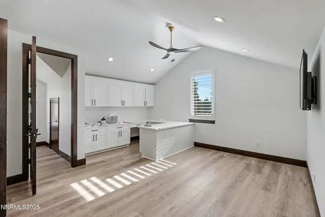 a kitchen with a refrigerator and a stove top oven
