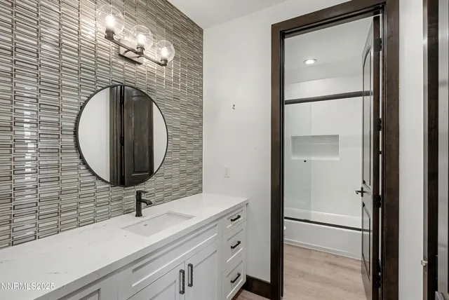 a bathroom with a sink and a mirror