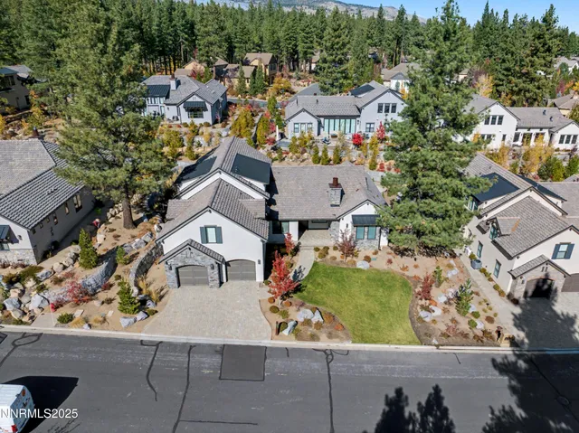 an aerial view of multiple houses with a yard