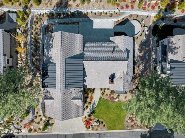 an aerial view of a house with a yard
