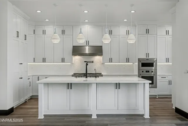 a kitchen with kitchen island cabinets and stainless steel appliances