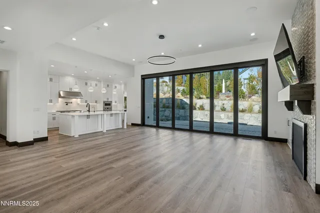 a view of a kitchen with furniture wooden floor and a large window