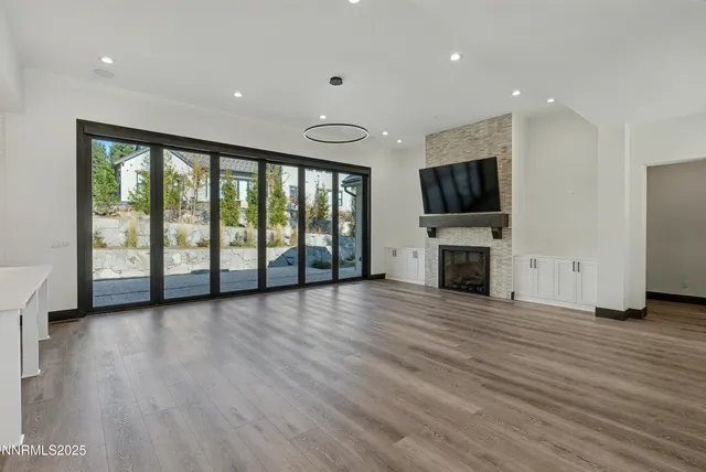 a view of a livingroom with an empty space and a fireplace