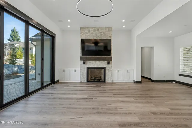 a view of a livingroom with an empty space and a fireplace
