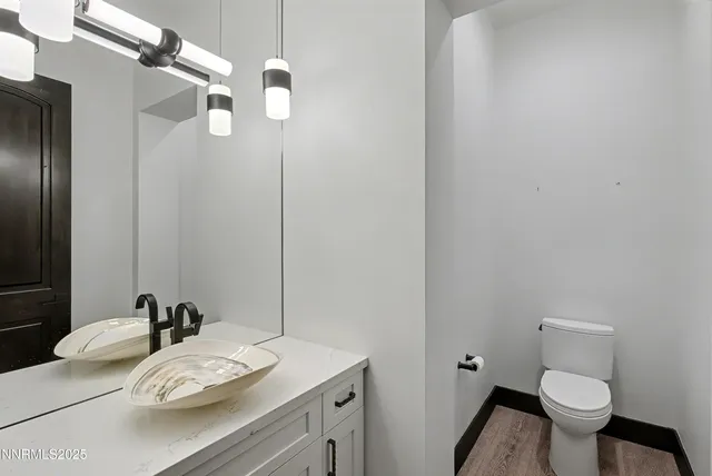 a bathroom with a sink vanity granite and toilet