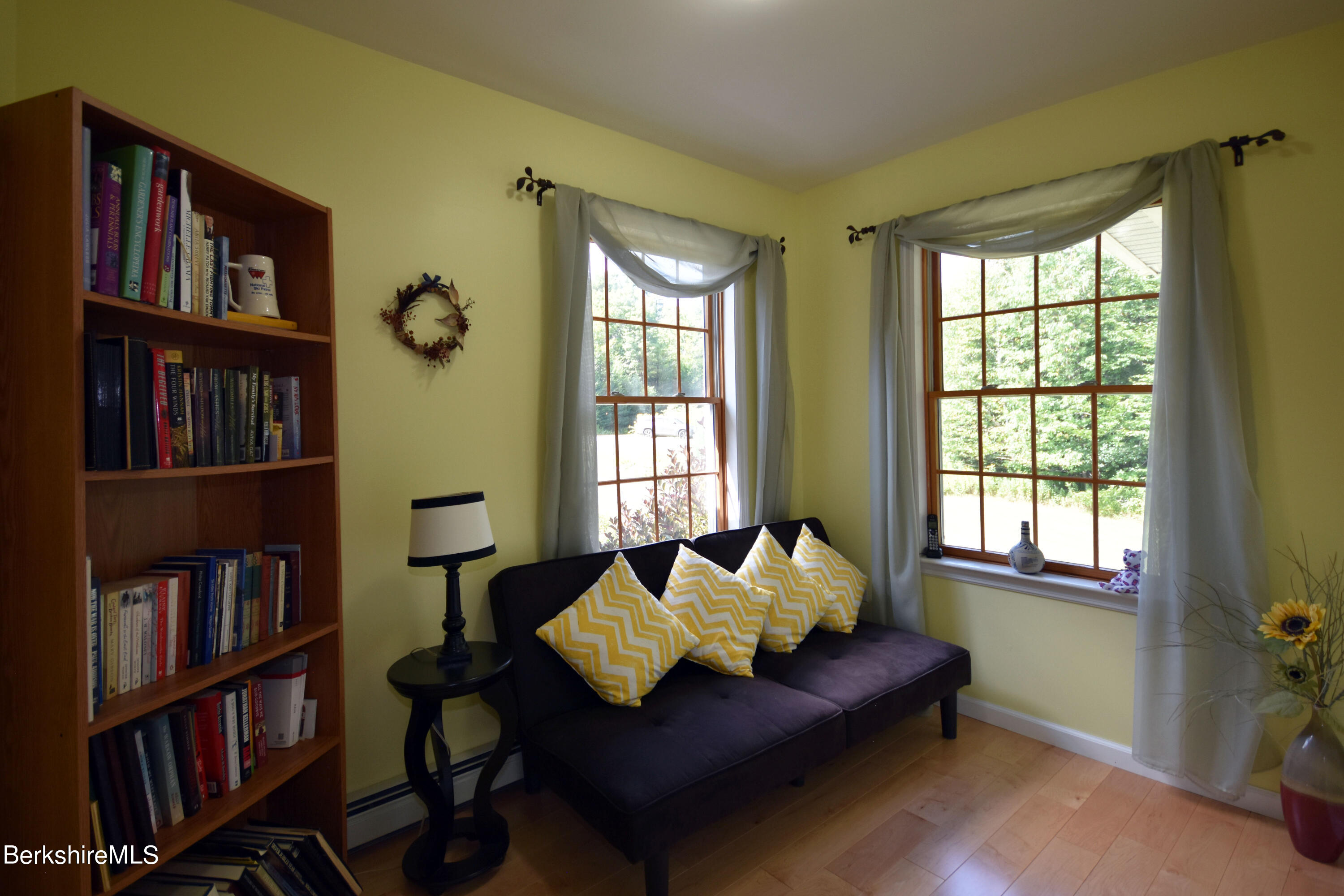 1540 East Windsor Road Windsor, MA 01270 - Photo 23 of 52 a living room with furniture and a book shelf