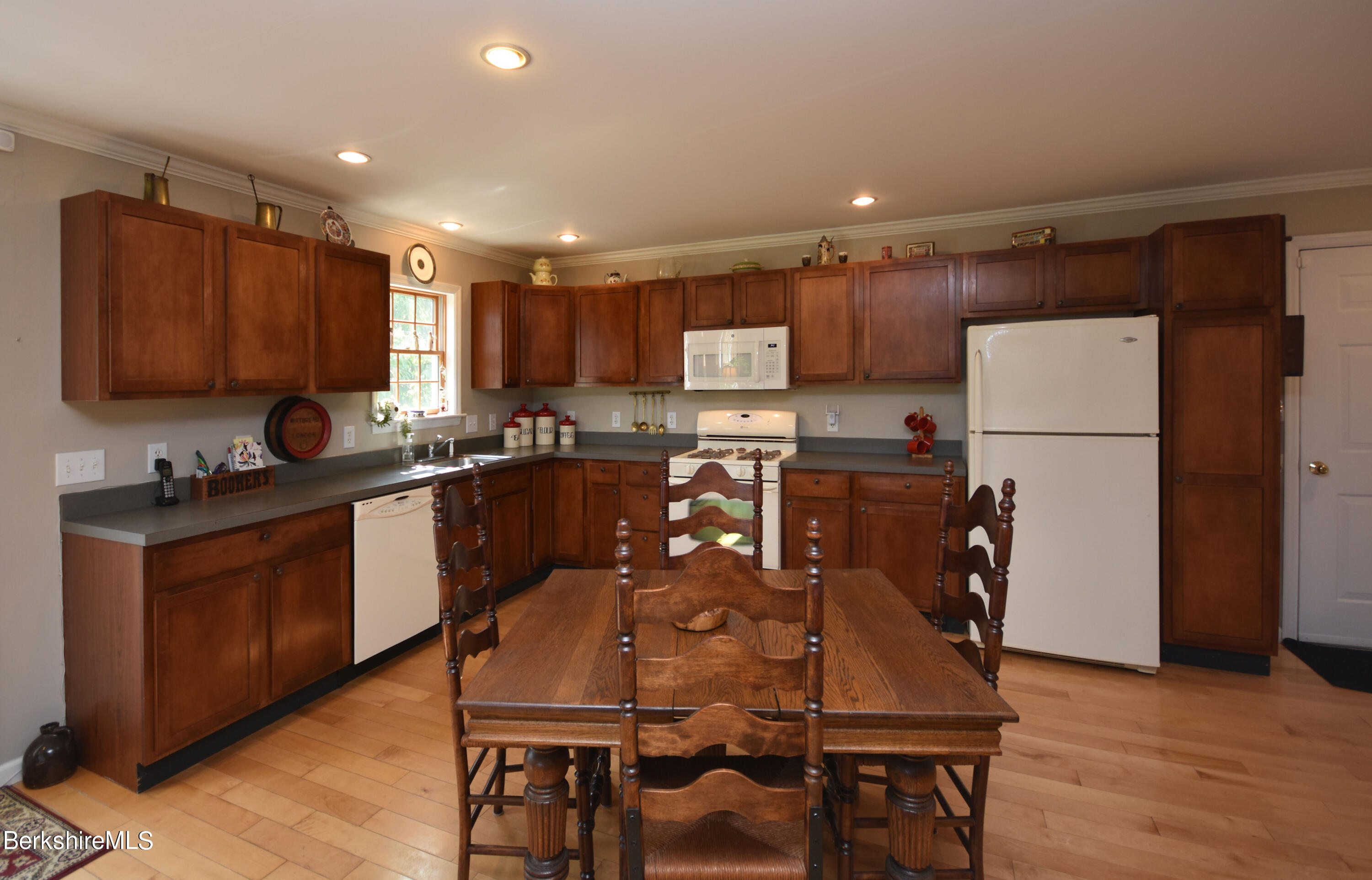 1540 East Windsor Road Windsor, MA 01270 - Photo 8 of 52 a kitchen with stainless steel appliances granite countertop wooden cabinets a refrigerator a sink a stove a dining table and chairs