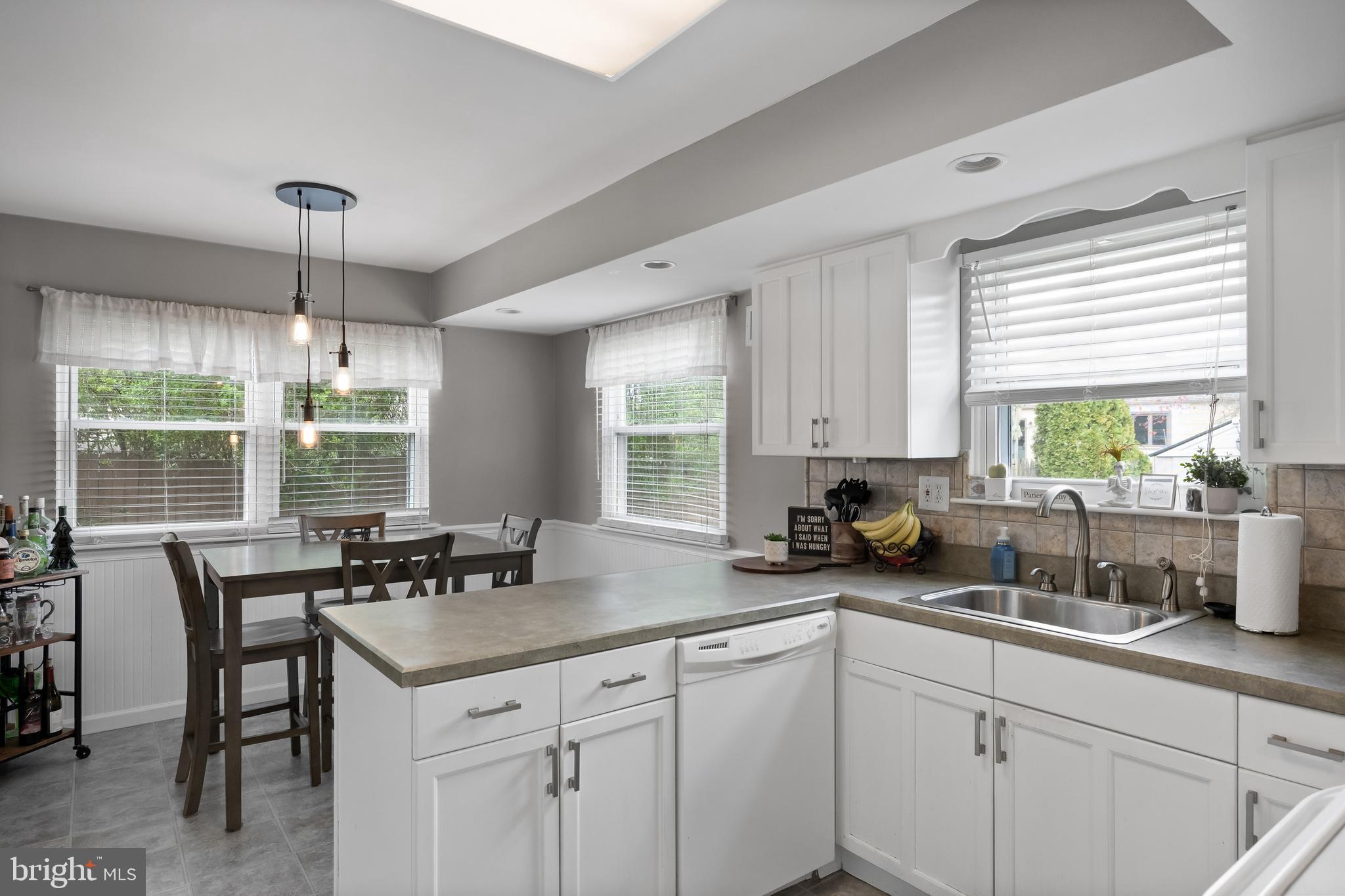19 Draco Drive Sewell, NJ 08080 - Photo 12 of 34 a kitchen with sink a window and dining table