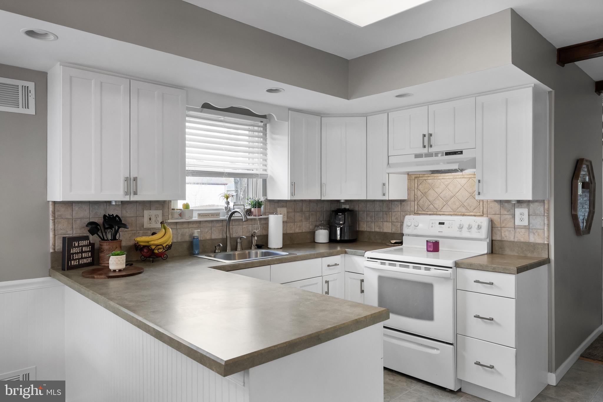 19 Draco Drive Sewell, NJ 08080 - Photo 13 of 34 a kitchen with white cabinets and white appliances
