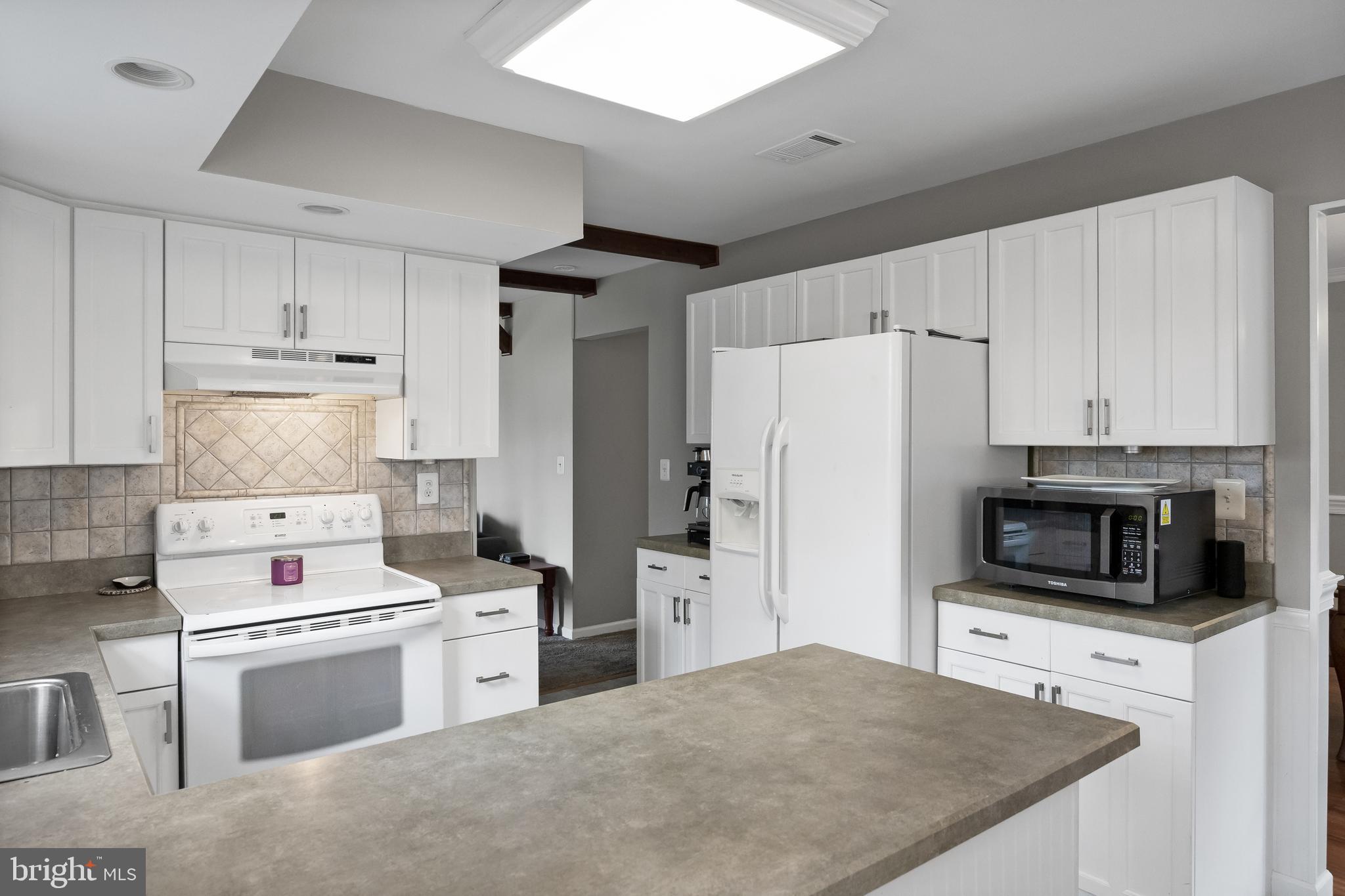 19 Draco Drive Sewell, NJ 08080 - Photo 14 of 34 a kitchen with kitchen island a white cabinets and refrigerator