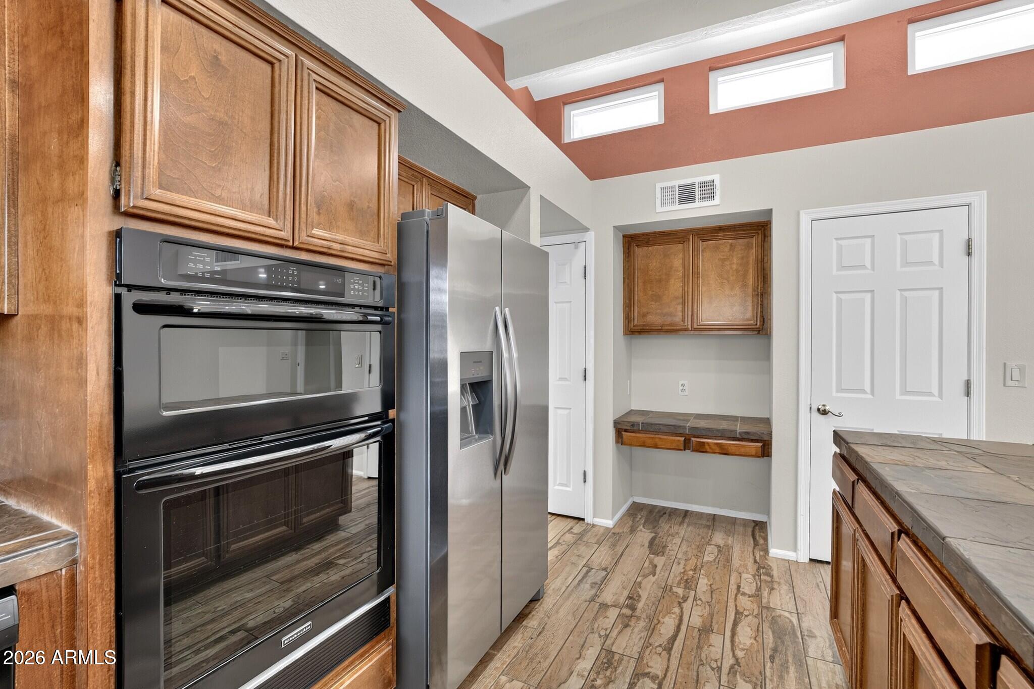 4615 East Monte Way Phoenix, AZ 85044 - Photo 35 of 35 a kitchen with stainless steel appliances granite countertop a refrigerator and a stove top oven