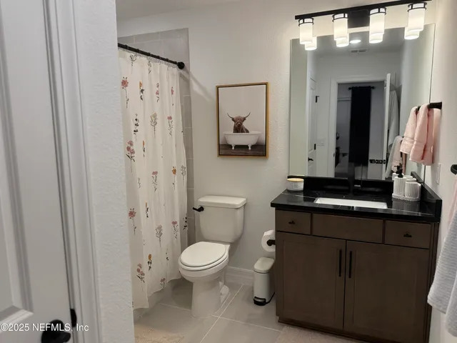 a bathroom with a toilet a sink and a mirror