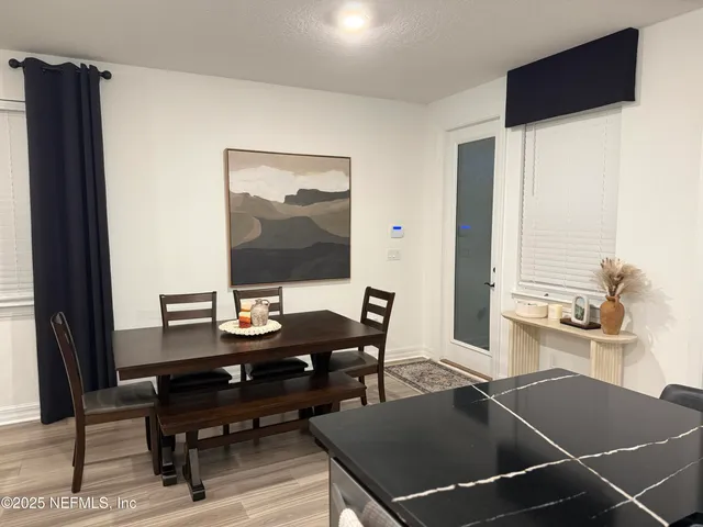 a dining room with furniture and wooden floor