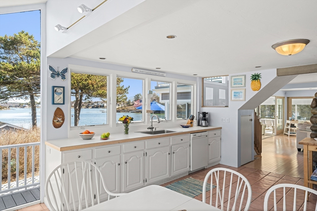 62 Crafts Road Gloucester, MA 01930 - Photo 14 of 40 a kitchen with stainless steel appliances kitchen island granite countertop a sink and cabinets