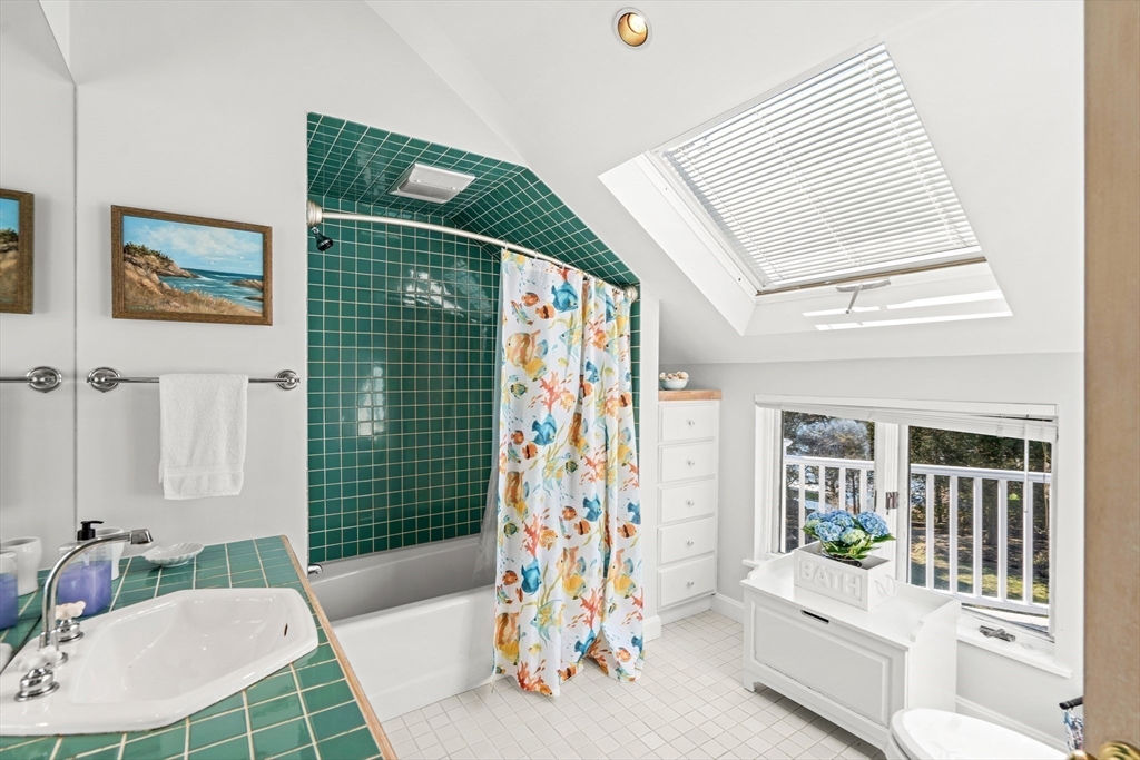 62 Crafts Road Gloucester, MA 01930 - Photo 24 of 40 a living room with patio furniture and a table