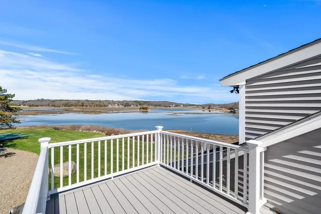 a view of balcony with wooden floor and outdoor seating