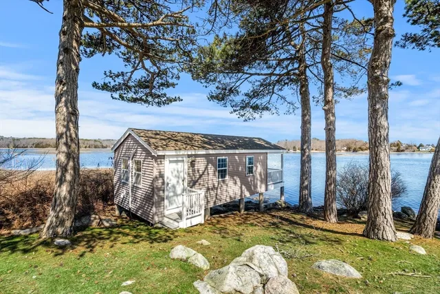a view of a house with swimming pool and sitting area