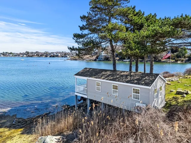 a front view of a house with a yard garage and outdoor seating