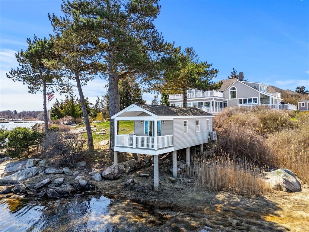 62 Crafts Road Gloucester, MA 01930 - Photo 31 of 40 a front view of a house with a yard garage and outdoor seating