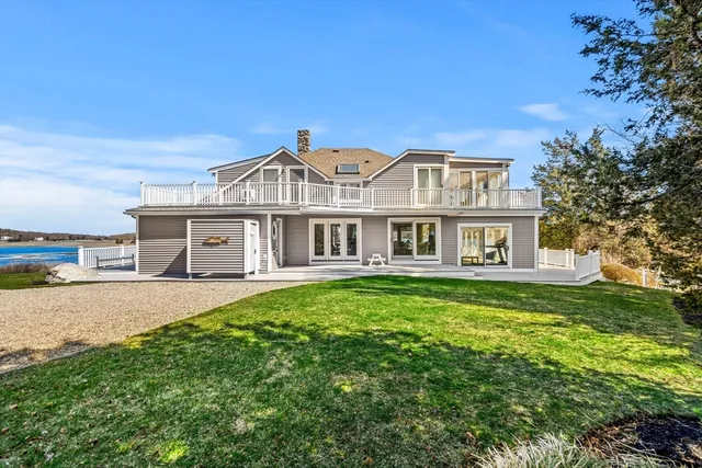 an aerial view of a house with a garden and lake view