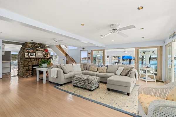 a living room with furniture flat screen tv and a large window