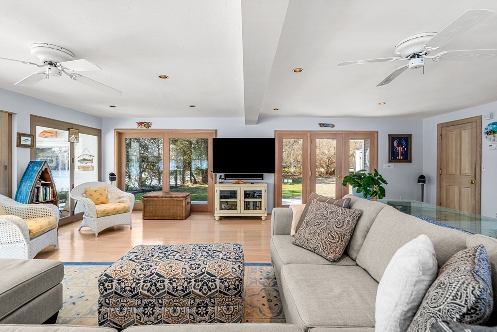 62 Crafts Road Gloucester, MA 01930 - Photo 6 of 40 a living room with furniture flat screen tv and a large window