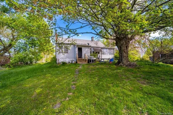 a front view of house with yard and trees