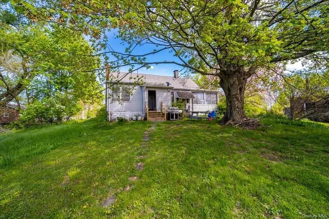 a front view of house with yard and trees