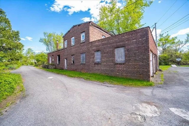 a view of backyard with table and chairs and a large tree