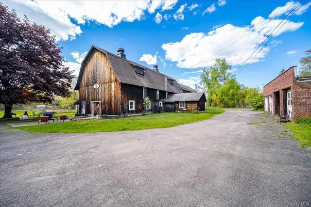 a view of an house with backyard space and garden