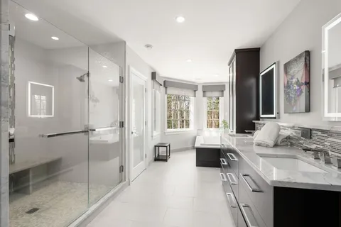a spacious bathroom with a shower sink and mirror
