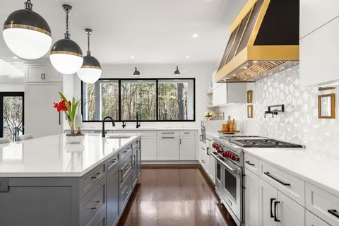 a kitchen with stainless steel appliances a stove a sink and a wooden cabinets