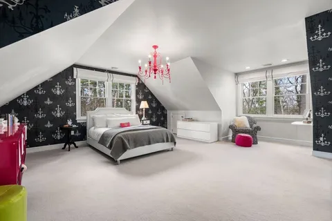 a bedroom with furniture and a chandelier