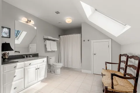 a kitchen with a stove a sink and chairs