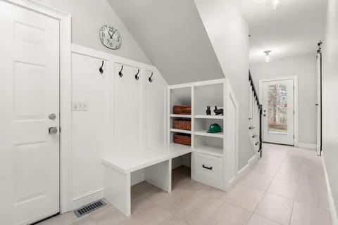 a view of an entryway with wooden floor